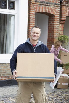 Company van parked outside with staff preparing to handle items